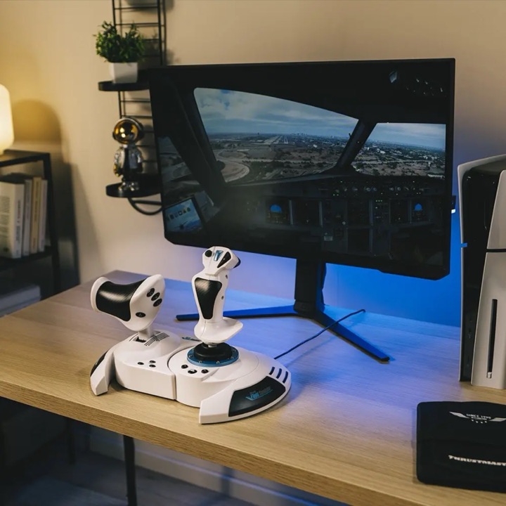 Thrustmaster T.Flight HOTAS on a desk in front of a PlayStation 5 and monitor